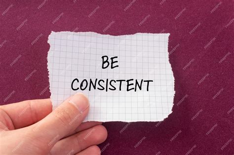 Premium Photo | Be consistent words written on torn paper with purple ...