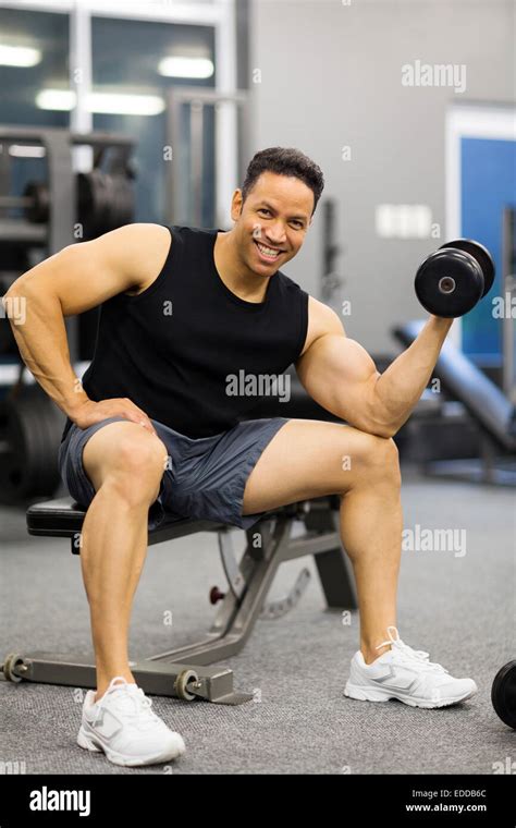 cheerful man lifting weights at gym Stock Photo - Alamy