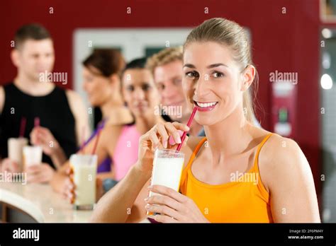 People drinking protein shake after workout in gym or fitness club ...