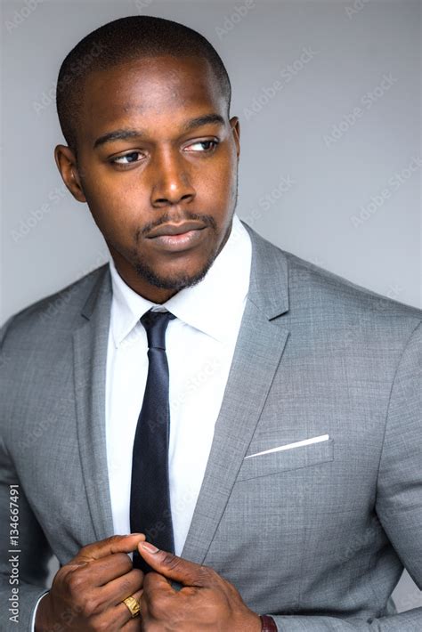Stylish handsome black male in modern fashion suit and tie looking ...
