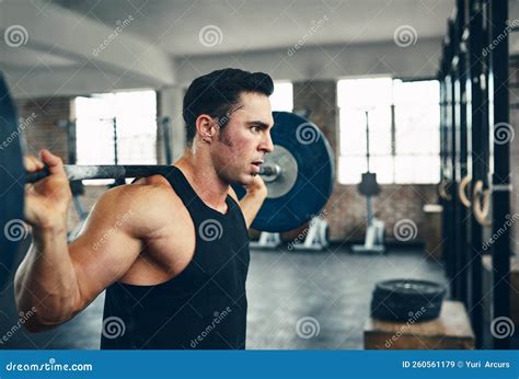 Focused on His Fitness Goals. a Man Lifting Weights at the Gym. Stock ...