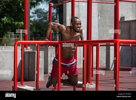 Athlete doing exercises at stadium Stock Photo - Alamy
