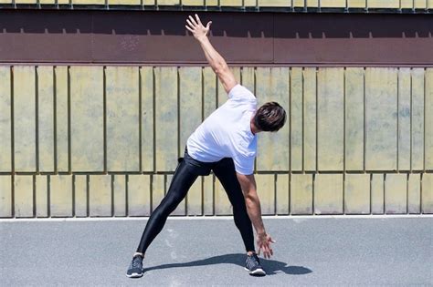 Premium Photo | Confident young man exercising during sunny day