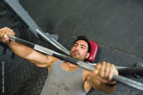 Handsome man lifting heavy weights Stock Photo | Adobe Stock