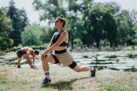 People Exercising Outdoors with Lunges by a Lake in a Sunny Park for Fitness and Health Stock ...