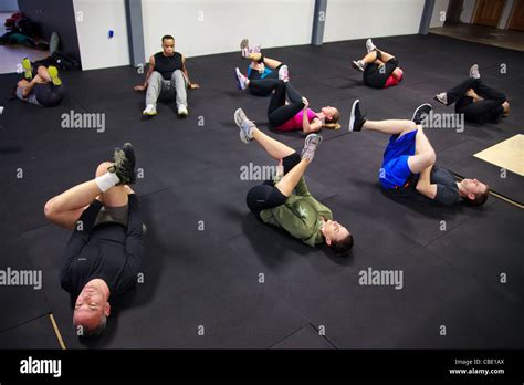 Group of athletes stretching hips in gym after workout Stock Photo - Alamy