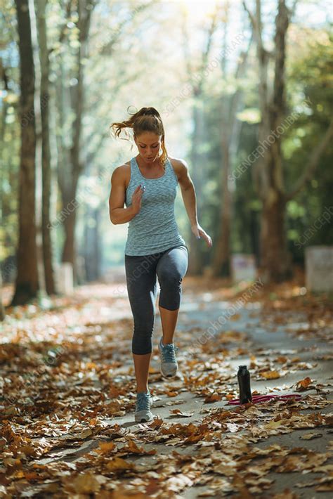 Woman exercising outdoors - Stock Image - F024/4566 - Science Photo Library