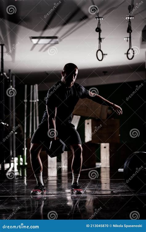 Silhouette of a Muscular Athlete Lifting Very Heavy Weights. Man ...