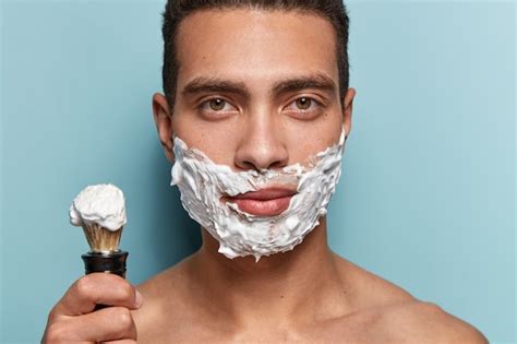 Free Photo | Portrait of young man applying shaving cream