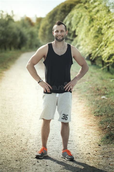 Energetic Young Man Do Exercises Outdoors and Running in Park To Stock ...