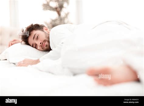 closeup.the tired men sleep soundly on the bed Stock Photo - Alamy