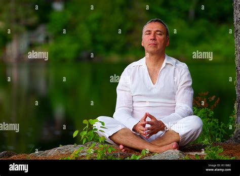 Man meditating outdoors hi-res stock photography and images - Alamy