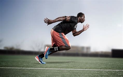 Download Running Athlete In Track And Field Wallpaper | Wallpapers.com