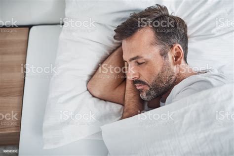 Man Sleeping Peacefully In Bed Stock Photo - Download Image Now ...