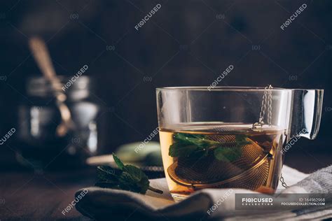 Steaming cup of tea on dark — cozy, drink - Stock Photo | #164962968
