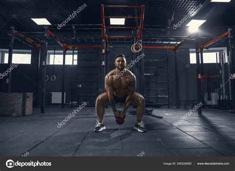 The male athlete training hard in the gym. Fitness and healthy life ...