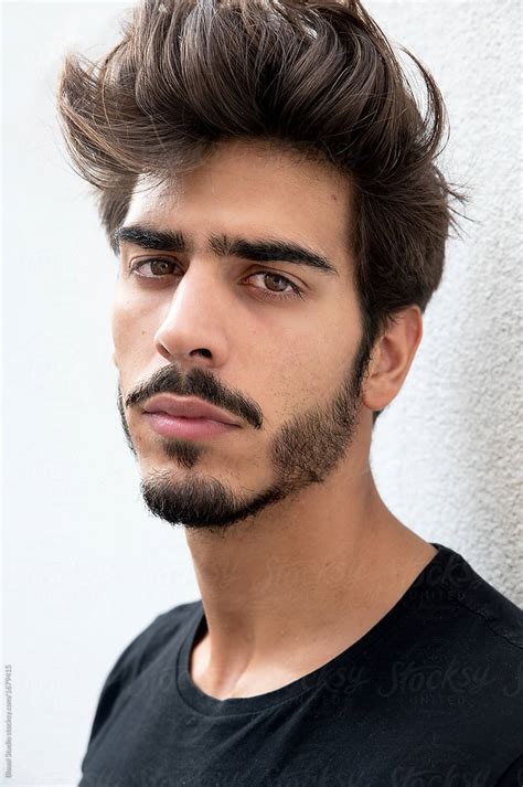 «Portrait Of A Handsome Young Man With Goatee Looking At Camera» del colaborador de Stocksy ...