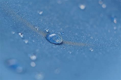 Premium Photo | Water beading on fabric Waterproof coating background with water drops