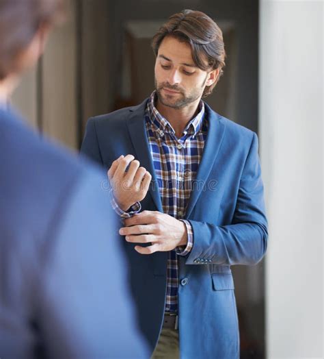 Getting Ready for the Day. Shot of a Handsome Man Getting Ready for ...