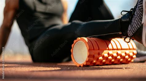 Man foam rolling. Athlete stretches using foam roller. Stock Photo ...