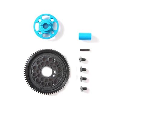 What is the primary factor limiting the speed at which a spur gear can operate efficiently without excessive noise or wear?